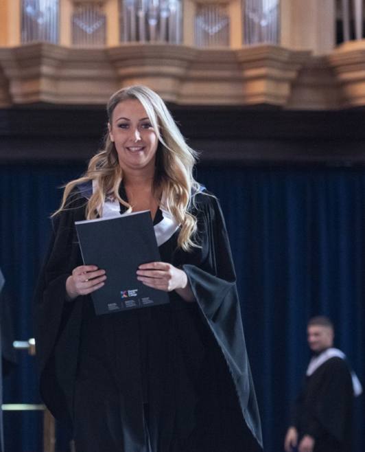 Female graduate with certificate Female graduate with certificate